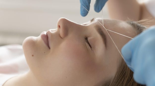 close-up-young-woman-getting-eyebrow-treatment close-up-young-woman-getting-eyebrow-treatment